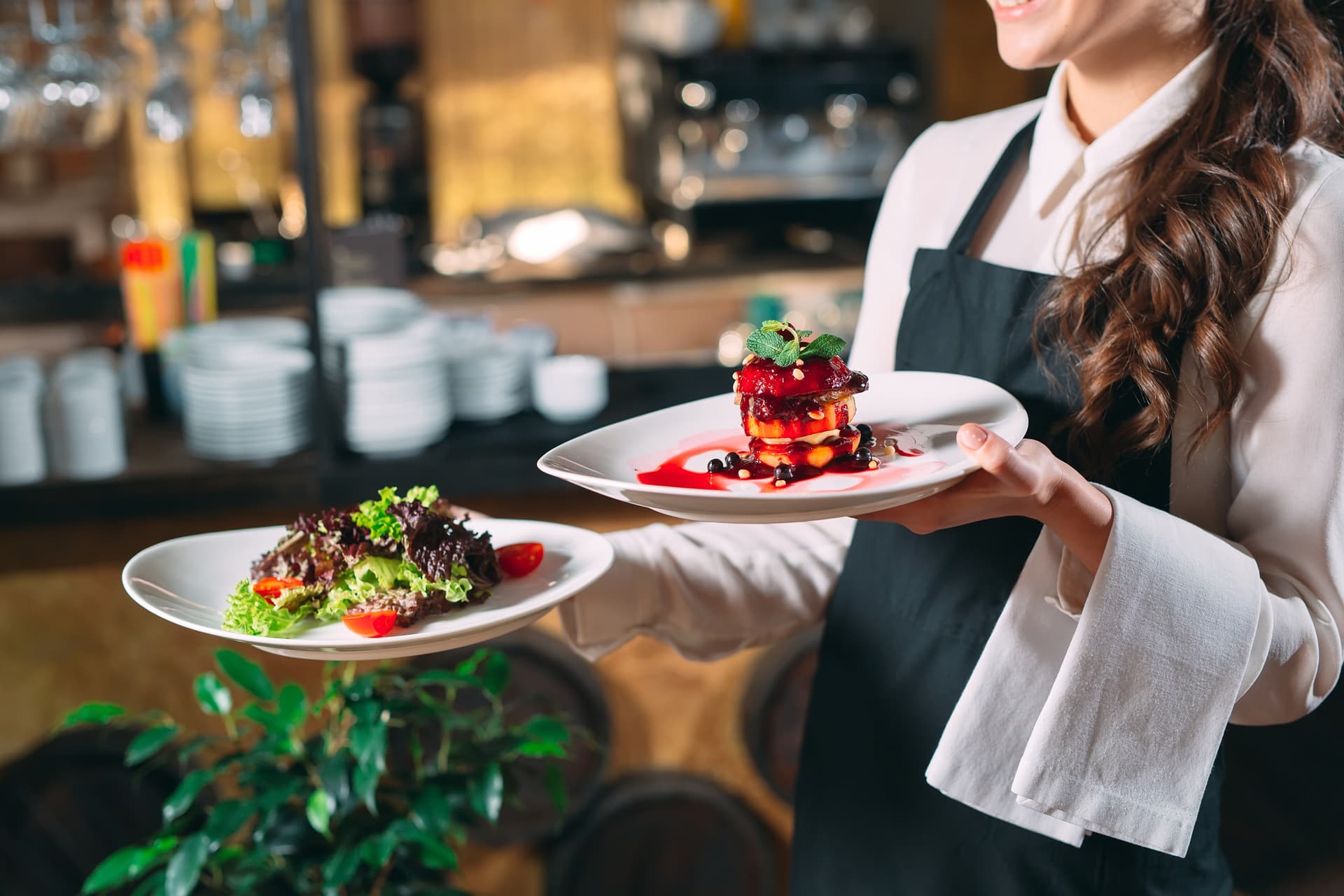 Waiter serving dishes at a busy restaurant